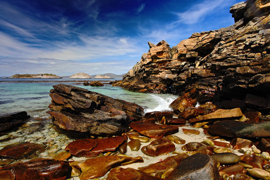 Blue sea and sky, waves breaking off shore, beautiful rock coast, California, USA