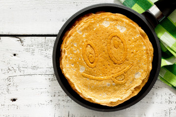 A stack of pancakes in a frying pan, traditional for Russian Car