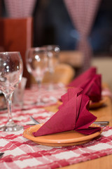Glasses napkin and silver utensils on the tavern table