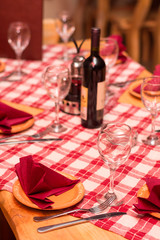 Glasses napkin and silver utensils on the tavern table