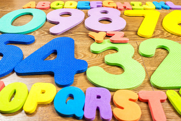 plastic numbers and letters on wooden background