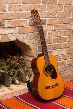 Accoustic guitar on the brick wall