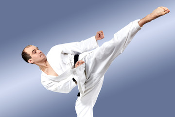 In karate gi sportsman beats roundhouse kick © andreyfire