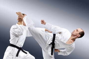 With black belt athletes train karate kick and blocks © andreyfire