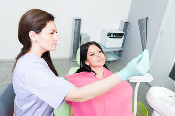 Dentist doctor and patient examining teeth xray