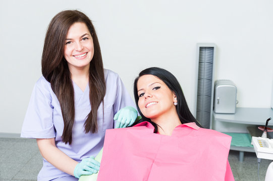 Confident dentist doctor and smiling female patient
