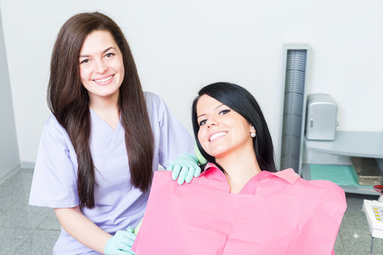 Friendly and successful female dentist doctor and patient