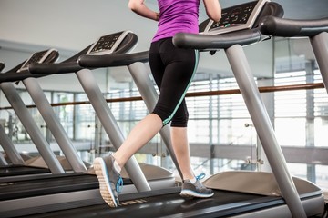 Lower section of fit woman on treadmill