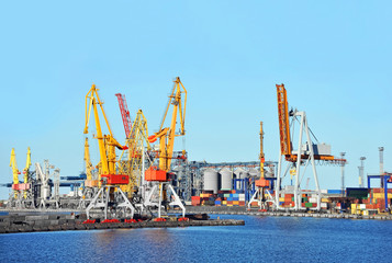 Fototapeta na wymiar Port cargo crane and container over blue sky background