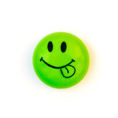 The fridge magnet - a smiley face with tongue stuck out