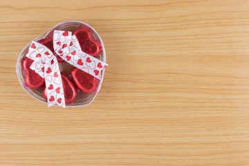 chocolate candy red heart in gift box with ribbon on wooden back