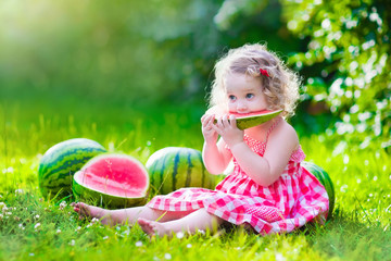 Little girl eating watermelon