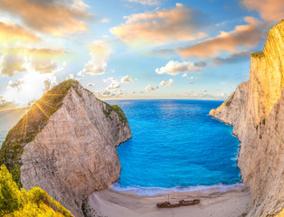 Navagio beach with shipwreck against colorful sunset on Zakynthos island in Greece