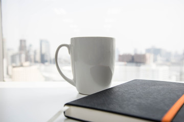 A cup of coffee with notebook
