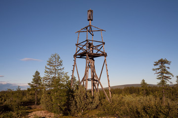 Old wooden triangulation tower in the forest. Yakutia. Russia.
