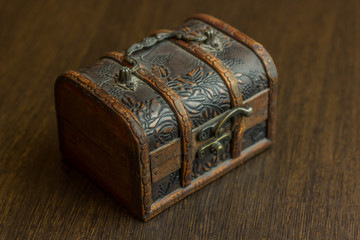 closed treasure chest on wooden table