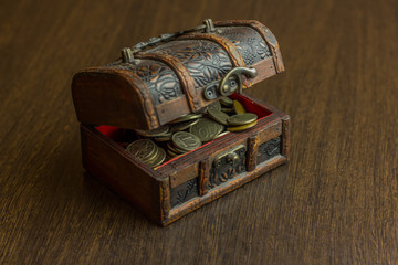 Treasure chest with old russian coin and have a wood floor in the background