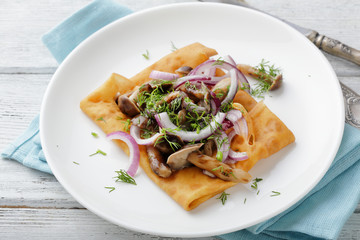 thin pancake with mushroom sauce