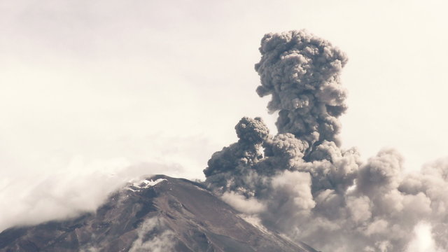 Tungurahua volcano crater telephoto shot captures the breathtaking 2015 explosion,showcasing a massive eruption with a significant release of volcanic ash into the sky.