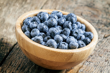 Wet blueberries in bowl, selective focus