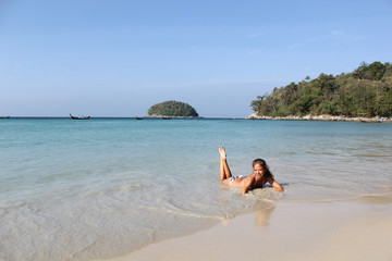 Fototapeta na wymiar Lovely young woman on the sunny Kata beach, Phuket, Thailand