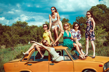 Six beautiful woman on the old car.