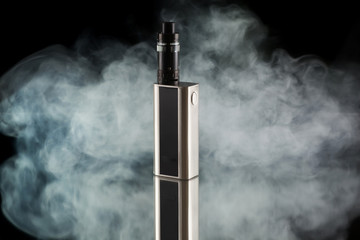 Battery mod or e-cigarette with tank at smoke on black background - 102612207