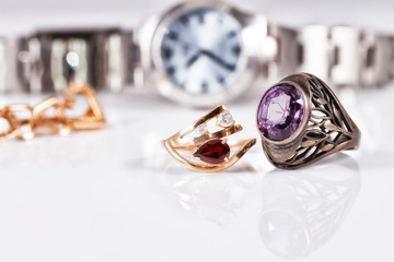 Gold earrings and rings with red rubies and watch