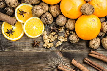 Christmas background. Christmas composition with oranges, walnuts, anise  and cinnamon on wood.