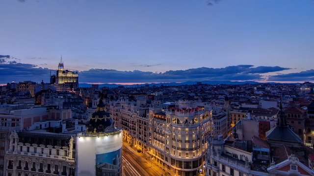 Panoramic aerial view of Gran Via day to night timelapse, Skyline Old Town Cityscape, Metropolis Building, capital of Spain, Europe.