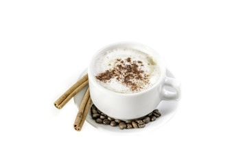 a cup of cappuccino  with cinnamone and star anise isolated on white