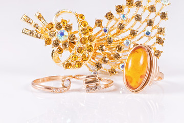 Big gold ring with amber and gold brooch