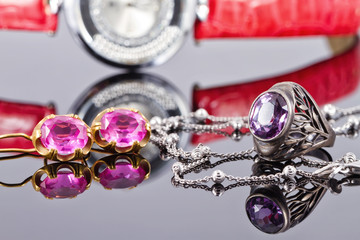 Gold earrings and rings with red rubies and watch