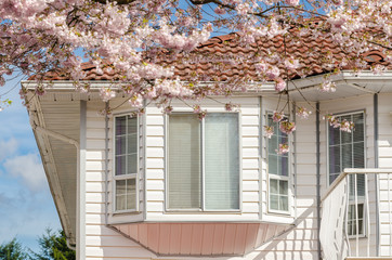 The roof of the house with nice window. Selective focus on the main subject (window).