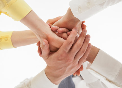 Business people uniting their hands - gesture of a uniion