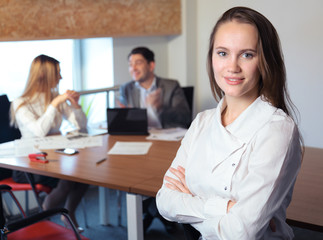 the girl in the office with working colleagues