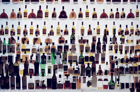 Various alcohol bottles in a bar, toned
