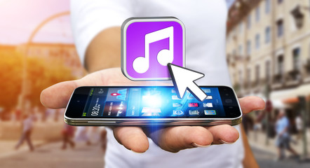 Young man using modern mobile phone to listen music