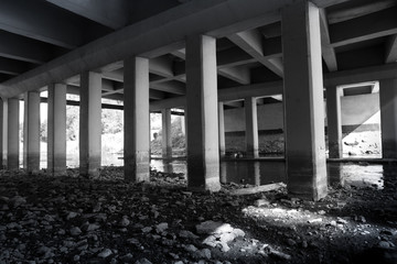 Grunge urban scene under automotive bridge.