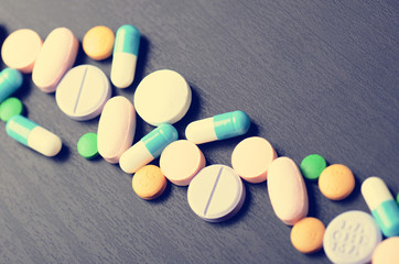 Pharmacy background on a black table. Tablets on a black background. Pills. Medicine and healthy. Close up of capsules.