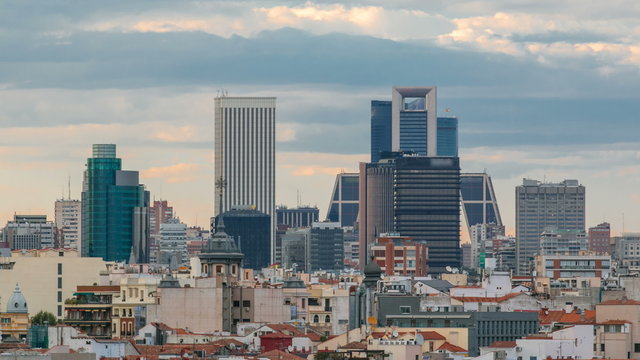 Madrid Skyline at sunset timelapse with some emblematic buildings such as Kio Towers
