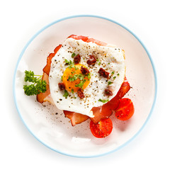 Breakfast - breadroll, fried egg, bacon and vegetables 