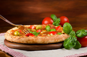 homemade pizza with salami, pepperoni, Basil and tomatoes