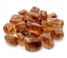 Brown caramelized lump cane sugar cube isolated on white backgro