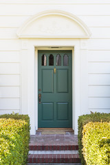 Fototapeta premium Narrow front green door