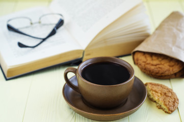 Fresh coffee with cookie and book