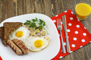 Breakfast with fried eggs, sausage, marinade mushrooms and bread