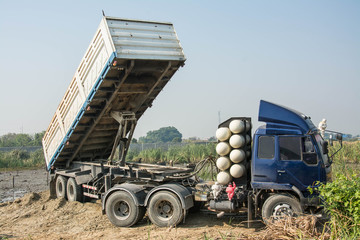 Dumper truck unloading soil  at construction site 