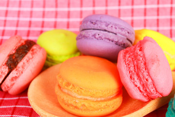 Colourful tasty macaroons in spoon