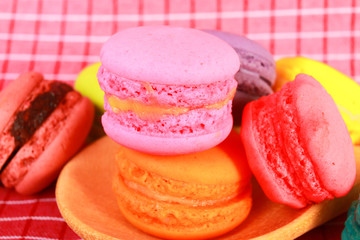 Colourful tasty macaroons in spoon